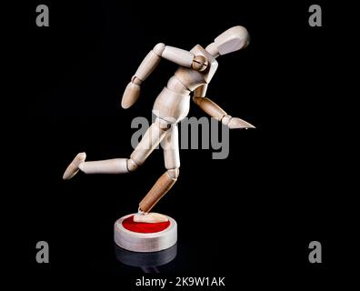 Image of falling wooden manikin on black background, wooden manikin poses different posing Stock Photo