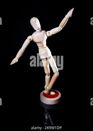 Image of falling wooden manikin on black background, wooden manikin poses different posing Stock Photo