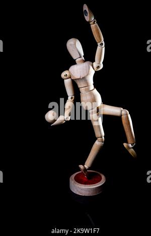 Image of falling wooden manikin on black background, wooden manikin poses different posing Stock Photo
