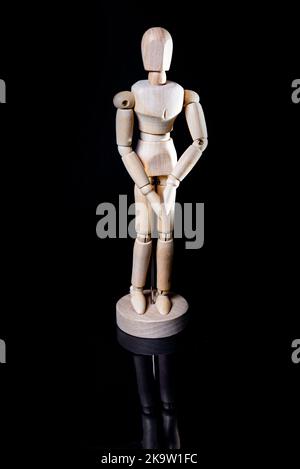 Image of falling wooden manikin on black background, wooden manikin poses different posing Stock Photo