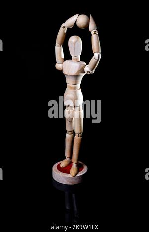 Image of falling wooden manikin on black background, wooden manikin poses different posing Stock Photo