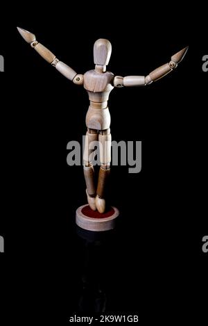 Image of falling wooden manikin on black background, wooden manikin poses different posing Stock Photo