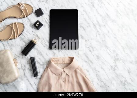 Fashion and Beauty blog concept. Different female accessories, clothing, shoes, bag, makeup , perfume  and tablet with copy space on modern beige back Stock Photo