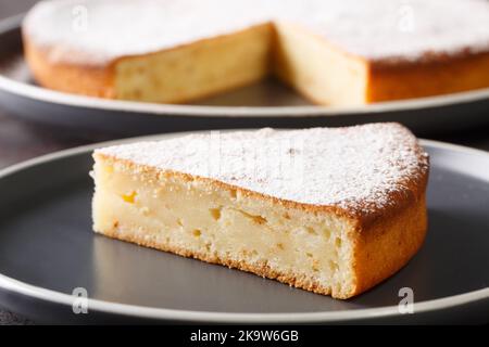 Homemade yogurt cake from simple ingredients close-up on a plate on the table. Horizontal Stock Photo