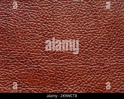 Genuine brown color leather skin natural with design lines pattern or red abstract background. Genuine leather texture. Use wallpaper or backdrop Stock Photo