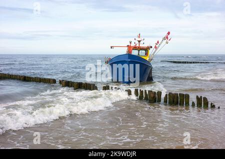 Fishing boat stranded on a beach. Stock Photo