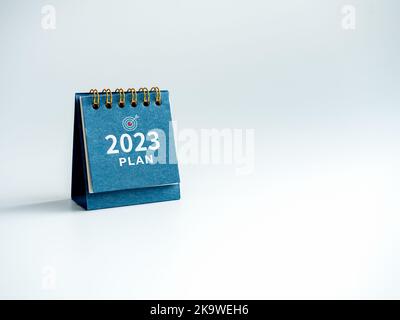 Happy new year 2023 background. 2023 numbers year withtext  'PLAN', word, and target icon on blue desk calendar isolated on white background with copy Stock Photo