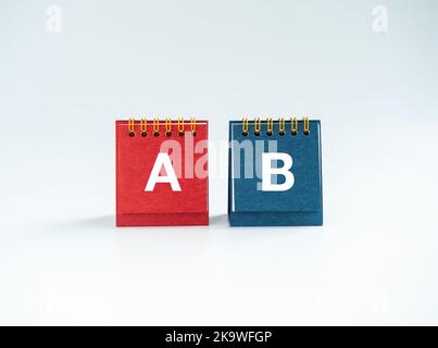 Planning choice concept. A and B text on red and blue color of standing desk calendar cover, front view, isolated on white background. Choosing betwee Stock Photo