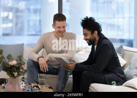 Two multi ethnic colleagues, businessmen using digital tablet in office Stock Photo
