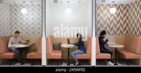 Workflow in modern coworking space of three diverse businesspeople Stock Photo
