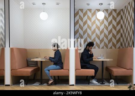 Two Indian freelancer working in coworking use modern technologies Stock Photo