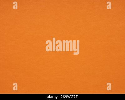 Orange paper, cardboard texture. Effect for winter season festival card, patchwork, new year designs decoration, background concepts, text, lettering Stock Photo