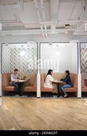 Diverse businesspeople working seated in modern coworking office Stock Photo
