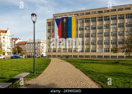 Czech Interior Ministry building with banner. Russian president, Vladimir Putin, in a black body bag between flags of the Czech Republic and Ukraine. Stock Photo