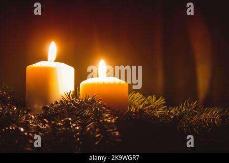 Christmas candles and ornaments over dark background with lights Stock Photo