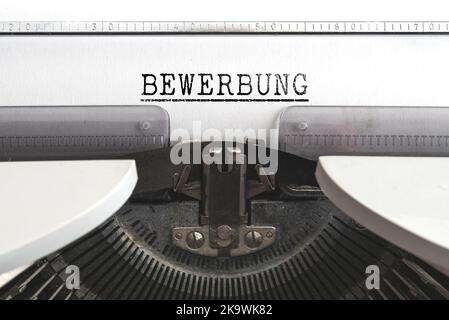 close-up view of word BEWERBUNG, German for job application, written on old mechanical typewriter Stock Photo