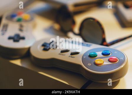 Old popular game console with joysticks. Stock Photo