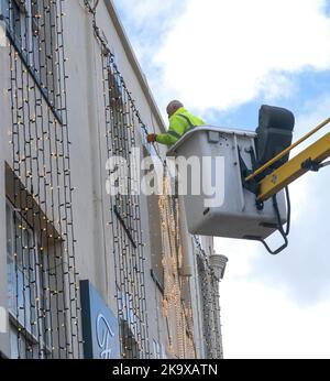 Sidmouth, Devon, 30th Oct 2022 Though not even November, contractors put up Christmas lights outside Fields department store in Sidmouth, Devon Tony Charnock/Alamy Live News Stock Photo
