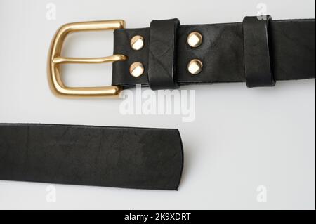 Classic leather belt ends isolated close up view Stock Photo