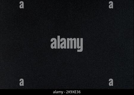 Black grainy paper texture background macro close up view Stock Photo