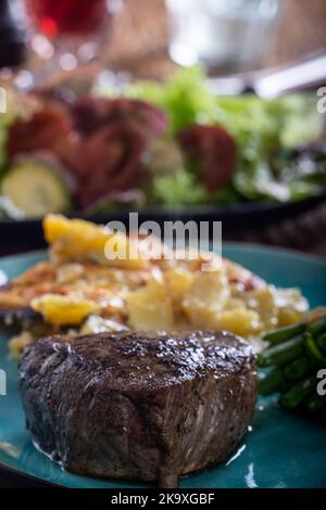 steak with beans and potato gratin Stock Photo