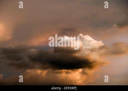 Dramatic threatening sky clouds sunset after tropical rain thunder storm Stock Photo