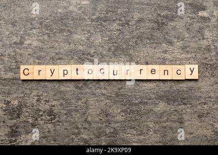 Cryptocurrency word written on wood block. Cryptocurrency text on cement table for your desing, concept. Stock Photo