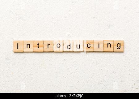 introducing word written on wood block. introducing text on table, concept. Stock Photo