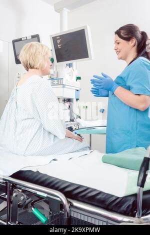 Nurse explaining procedure to patient in hospital surgery Stock Photo