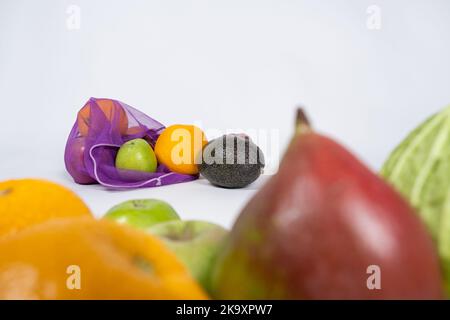 Fabric mesh for fruits and vegetables on a white background. A reusable alternative to plastic bags. Stock Photo
