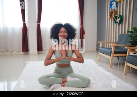 African young woman athlete losing weight, burning calories, doing workout training at home Stock Photo