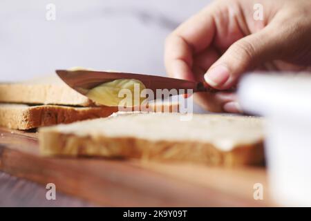 fresh butter spreading on a bread  Stock Photo
