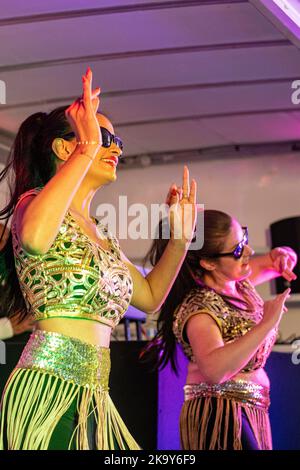 Dancers on stage in the rain for a Divali performance in Tooting, London Stock Photo