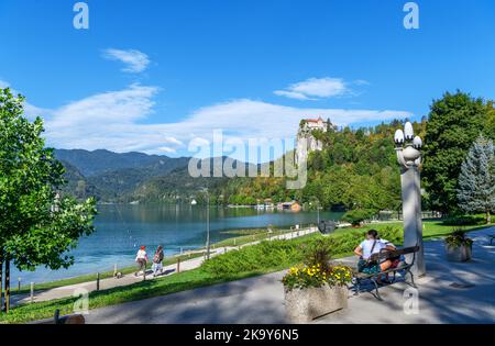 View along the lakefront towards Bled Castle, Bled village, Lake Bled, Slovenia Stock Photo