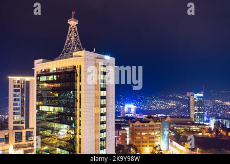 Kigali, Rwanda - August 17 2022: Kigali city centre lit up at night with Pension Plaza, City Tower and other buildings in view. Stock Photo