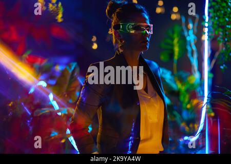 modern 40 years old business woman with futuristic goggles in virtual reality. Stock Photo