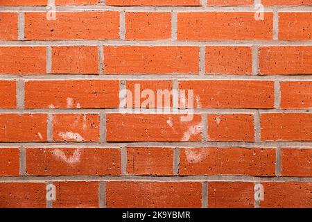 two handprints on a red red brick wall Stock Photo