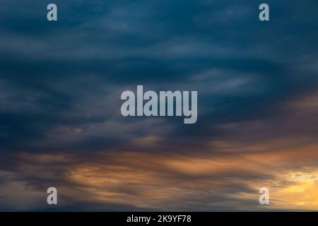 Dramatic clouds at sunrise. Weather background photo. Blue and orange clouds. Stock Photo