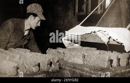 A circa 1940's photograph of powdered beryllium ore being baked into bricks at  Reading, Pennsylvania. Though beryllium was discovered in the late 18th century, its commercial value  and distinct properties were not generally utilised until   the 1920s. Its dust is toxic, despite no apparent  health and safety measures being in place at the time this picture was taken. Stock Photo