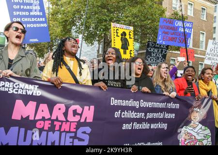 London, UK. 29th Oct, 2022. Protesters hold a banner and placards expressing their opinion during the demonstration. Parents and children took part in Pregnant Then Screwed's ‘March Of The Mummies' in central London demanding better childcare, parental leave and flexible working policies. The protesters marched from Trafalgar Square through Whitehall, passing Downing Street to Parliament Square. Credit: SOPA Images Limited/Alamy Live News Stock Photo