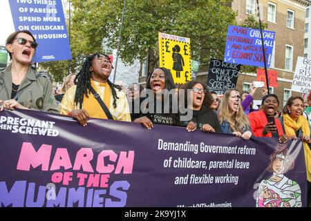 London, UK. 29th Oct, 2022. Protesters hold a banner and placards expressing their opinion during the demonstration. Parents and children took part in Pregnant Then Screwed's ‘March Of The Mummies' in central London demanding better childcare, parental leave and flexible working policies. The protesters marched from Trafalgar Square through Whitehall, passing Downing Street to Parliament Square. (Photo by Steve Taylor/SOPA Images/Sipa USA) Credit: Sipa USA/Alamy Live News Stock Photo