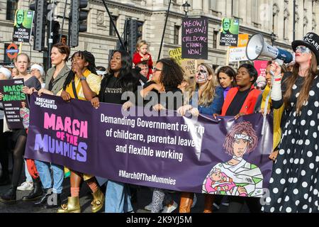 London, UK. 29th Oct, 2022. Protesters hold a banner and placards expressing their opinion during the demonstration. Parents and children took part in Pregnant Then Screwed's ‘March Of The Mummies' in central London demanding better childcare, parental leave and flexible working policies. The protesters marched from Trafalgar Square through Whitehall, passing Downing Street to Parliament Square. (Photo by Steve Taylor/SOPA Images/Sipa USA) Credit: Sipa USA/Alamy Live News Stock Photo