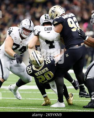 New Orleans, USA. 30th Oct, 2022. New Orleans Saints defensive end Marcus Davenport (92) and linebacker Pete Werner (20) sack Las Vegas Raiders quarterback Derek Carr (4) during a National Football League contest at Caesars Superdome in New Orleans, Louisiana on Sunday, October 30, 2022. (Photo by Peter G. Forest/Sipa USA) Credit: Sipa USA/Alamy Live News Stock Photo