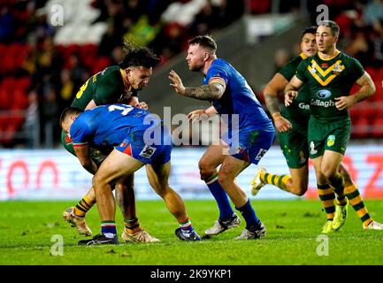 Australia's Tino Fa'asuamaleaui is tackled by Italy's Anton Iaria during the Rugby League World Cup group B match at the Totally Wicked Stadium, St Helens. Picture date: Saturday October 29, 2022. Stock Photo
