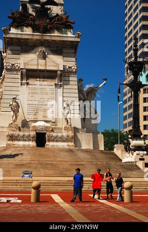 A family of tourists walk around the Soldiers and Sailors Memorial located ion the center of downtown Indianapolis, Indiana Stock Photo