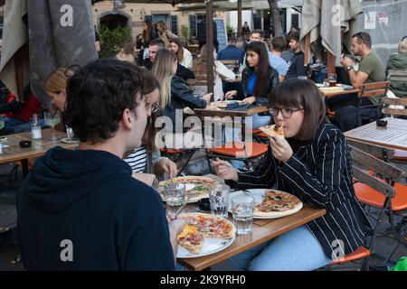 A young couple eat pizza at the Fany & Mary restaurant in Ljubjlana, Slovenia Stock Photo
