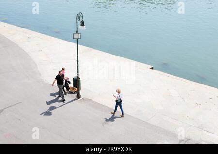 Turin, Italy. May 22, 2016. Some tourists stroll along the bank of the Po, the river that crosses the city Stock Photo