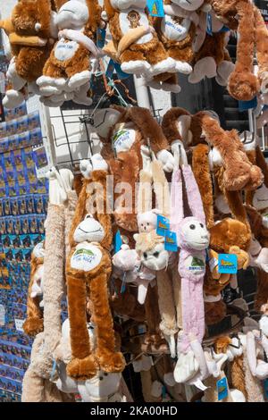 Gibraltar. 2nd September 2022.  Cuddly toy monkeys hanging on a display rack outside a gift shop in Main Street, Gibraltar. Stock Photo