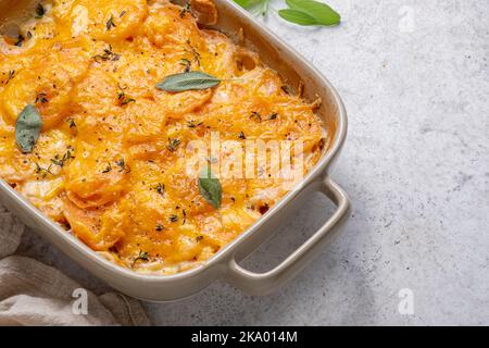 Sweet potato gratin with cream in baking dish Stock Photo