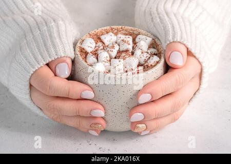 female hand holding cup of hot cocoa Stock Photo